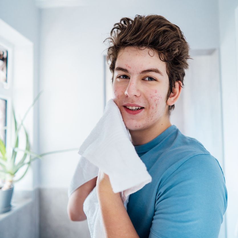 teen washing face to prevent acne