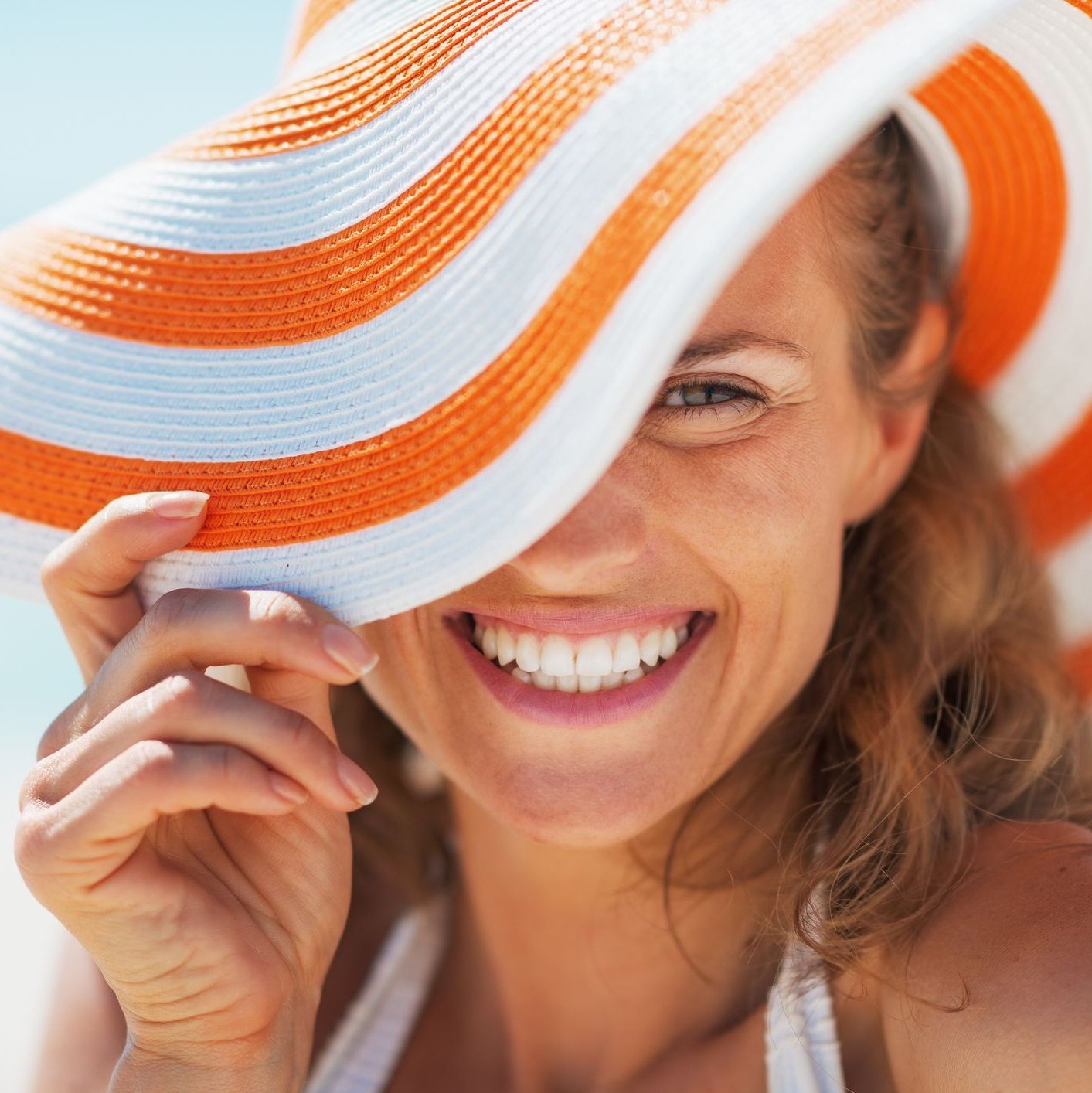 woman wearing a wide brimmed hat on the beach woman wearing a wide brimmed hat on the beach