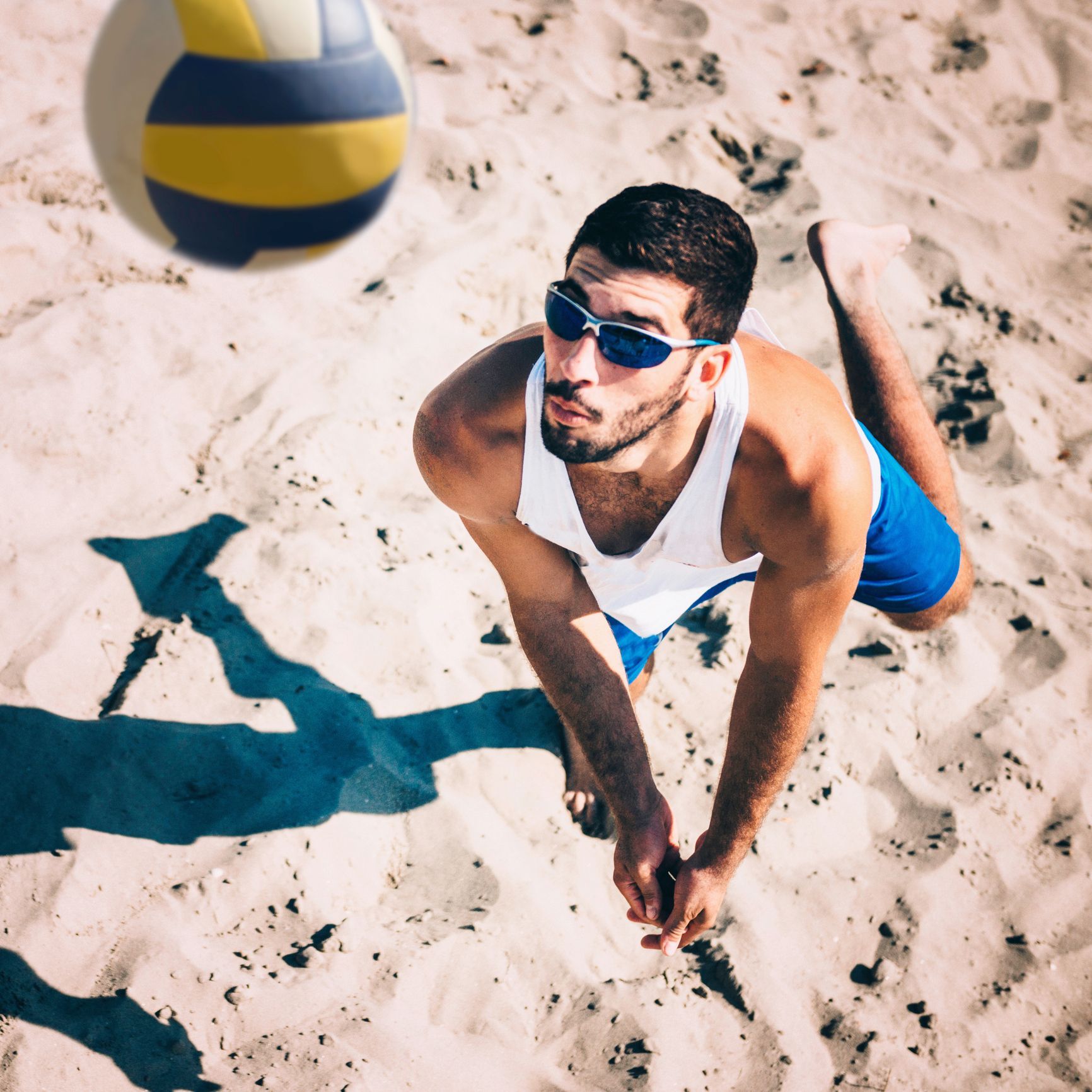 man playing volleyball wearing wraparound sunglasses man playing volleyball wearing wraparound sunglasses