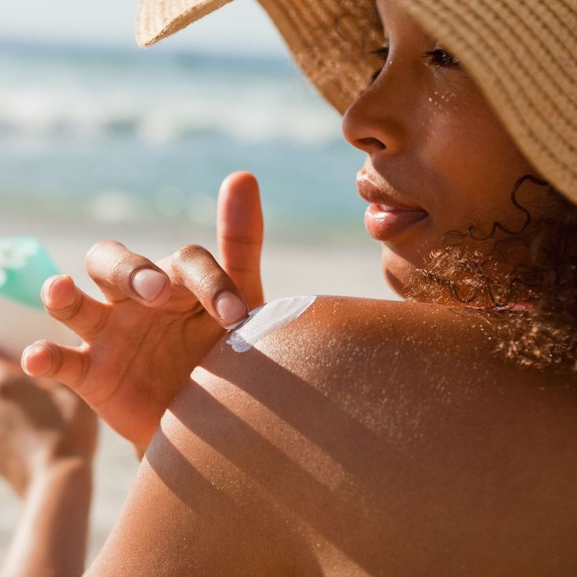 woman applying mineral sunscreen woman applying mineral sunscreen